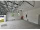 Spacious two-car garage with concrete floors and open ceiling at 14300 Kay Ln, Port Charlotte, FL 33981