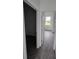 Bright hallway featuring wood-look tile flooring and doorways to bedroom and closet at 14300 Kay Ln, Port Charlotte, FL 33981