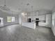 Open concept kitchen with white cabinets, gray flooring and stainless steel appliances at 14300 Kay Ln, Port Charlotte, FL 33981