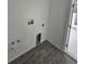 Laundry room hookups with gray wood-look tile at 14300 Kay Ln, Port Charlotte, FL 33981