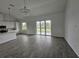Spacious open-plan living area with gray flooring and pond view at 14300 Kay Ln, Port Charlotte, FL 33981