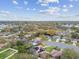 Extensive aerial view of the neighborhood, highlighting the community's layout, tree coverage, and proximity to amenities at 1508 Cascade Ct, Dunedin, FL 34698