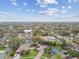 Expansive aerial view showcasing the neighborhood, community, and the home's location amidst lush greenery at 1508 Cascade Ct, Dunedin, FL 34698