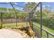 Manicured lawn behind a screened-in patio with privacy fence and a decorative water feature at 1508 Cascade Ct, Dunedin, FL 34698