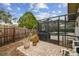 Backyard view of a grilling space, swimming pool, and surrounding privacy fence at 1508 Cascade Ct, Dunedin, FL 34698