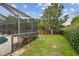 The backyard features a grassy area and a patio space that backs up to a privacy fence at 1508 Cascade Ct, Dunedin, FL 34698