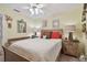 Comfortable bedroom features a ceiling fan, soft lighting, and relaxing decor creating a welcoming space at 1508 Cascade Ct, Dunedin, FL 34698