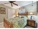 Bedroom with wicker furniture and tropical bedding features a closet and a nightstand at 1508 Cascade Ct, Dunedin, FL 34698