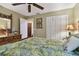 Bedroom with wicker furniture and tropical bedding features a closet and a decorative dresser at 1508 Cascade Ct, Dunedin, FL 34698