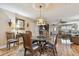 Inviting dining area features hardwood floors, a decorative chandelier, and flows into the living room at 1508 Cascade Ct, Dunedin, FL 34698