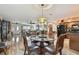 Bright dining area featuring a glass table, hardwood floors, and views of the living room and kitchen at 1508 Cascade Ct, Dunedin, FL 34698