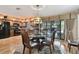 Open dining area adjacent to the pool, featuring a glass table and seamless indoor-outdoor living at 1508 Cascade Ct, Dunedin, FL 34698