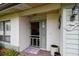 Close-up of the inviting front entrance with a decorative screen door and mermaid decor at 1508 Cascade Ct, Dunedin, FL 34698