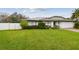 Charming front yard featuring a lush green lawn and a well-maintained landscape, enhancing the home's curb appeal at 1508 Cascade Ct, Dunedin, FL 34698