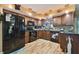Well-equipped kitchen featuring dark cabinets, modern appliances, and artistic accents at 1508 Cascade Ct, Dunedin, FL 34698