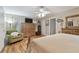 Cozy bedroom with hardwood floors, large dresser, and a comfortable chair by the window at 1508 Cascade Ct, Dunedin, FL 34698