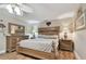 Spacious main bedroom with a ceiling fan, neutral tones, and wooden furniture at 1508 Cascade Ct, Dunedin, FL 34698