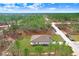 Drone image shows home with ample parking, large roof and green landscaping at 16394 Scaup Duck Ave, Weeki Wachee, FL 34614