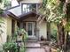 Inviting home entrance with a decorative glass door and verdant landscaping at 16921 Crawley Rd, Odessa, FL 33556