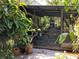 This screened porch offers a peaceful retreat surrounded by lush tropical foliage at 16921 Crawley Rd, Odessa, FL 33556
