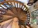 A wooden, winding staircase connects the various floors of the house at 16921 Crawley Rd, Odessa, FL 33556