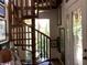 Unique spiral staircase leading to the upper level, bathed in natural light at 16921 Crawley Rd, Odessa, FL 33556