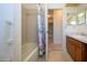 Bathroom with a tub/shower combination with a floral curtain and neutral tile at 1742 W Del Webb Blvd, Sun City Center, FL 33573