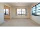 Empty bedroom with neutral carpeting, multiple windows and access to another room at 1742 W Del Webb Blvd, Sun City Center, FL 33573