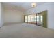 Bright and open living room featuring neutral carpet and large sliding glass doors at 1742 W Del Webb Blvd, Sun City Center, FL 33573