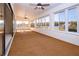 Bright sunroom featuring many windows, carpet, and ceiling fans at 1742 W Del Webb Blvd, Sun City Center, FL 33573