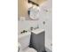Well-lit bathroom with gray vanity, updated shower, and neutral decor at 1910 E Chelsea St, Tampa, FL 33610