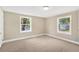 Sunlit bedroom with plush carpeting and large windows offering ample natural light at 1910 E Chelsea St, Tampa, FL 33610