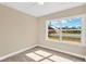 Bright bedroom with large window, plush carpet, and a tranquil atmosphere at 1910 E Chelsea St, Tampa, FL 33610