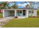 Charming single-story home with well-maintained lawn, carport, and inviting front porch at 1910 E Chelsea St, Tampa, FL 33610