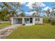 Charming single-story home featuring a spacious front yard and covered parking at 1910 E Chelsea St, Tampa, FL 33610