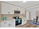 Modern kitchen boasts stainless steel appliances, white cabinets, and ample countertop space at 1910 E Chelsea St, Tampa, FL 33610