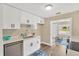 Bright kitchen features modern appliances, white cabinetry, and stylish countertop at 1910 E Chelsea St, Tampa, FL 33610