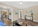 Bright living room with wood-look floors and stylish decor leading into the kitchen at 1910 E Chelsea St, Tampa, FL 33610