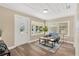 Cozy living room featuring wood-look floors, a large window, and comfortable seating at 1910 E Chelsea St, Tampa, FL 33610