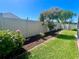 View of the fenced backyard featuring manicured landscaping and decorative elements for visual appeal and privacy at 2015 Golf Manor Blvd, Valrico, FL 33596