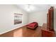 Bedroom with wood floors, window, and a dresser at 2015 Golf Manor Blvd, Valrico, FL 33596