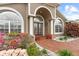 Elegant entrance with brick walkway, arched windows, and meticulous landscaping at 2015 Golf Manor Blvd, Valrico, FL 33596