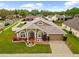 Inviting single-Gathering home featuring a well-manicured lawn and attached two-car garage at 2015 Golf Manor Blvd, Valrico, FL 33596