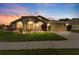 Charming home with beautiful landscaping, arched windows, and a two-car garage at 2015 Golf Manor Blvd, Valrico, FL 33596