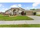 Attractive single-story home with manicured lawn and a two-car garage at 2015 Golf Manor Blvd, Valrico, FL 33596