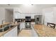Bright kitchen features granite counters, stainless steel appliances, and white cabinetry at 2015 Golf Manor Blvd, Valrico, FL 33596