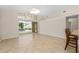Living room with tile floors and glass doors leading to the pool at 2015 Golf Manor Blvd, Valrico, FL 33596