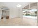 Open living room with tile floors, glass doors, and view of the pool at 2015 Golf Manor Blvd, Valrico, FL 33596