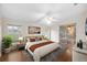 Bright main bedroom with a ceiling fan, en suite bath, and sliding glass door to patio at 2015 Golf Manor Blvd, Valrico, FL 33596