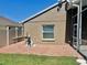 A side yard showcases a paved area and utility equipment, with a view extending towards the screened in back porch at 2015 Golf Manor Blvd, Valrico, FL 33596